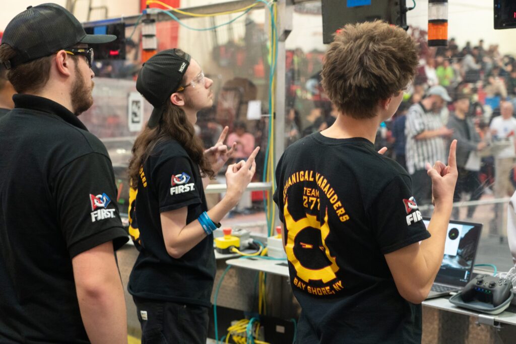 Team 271 Mechanical Marauders students and robot at competitions and in the shop
