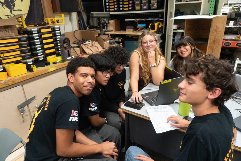Team 271 Mechanical Marauders students and robot at competitions and in the shop