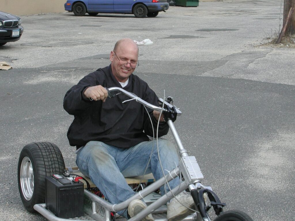 Pete Burke riding the team's trike, 2004