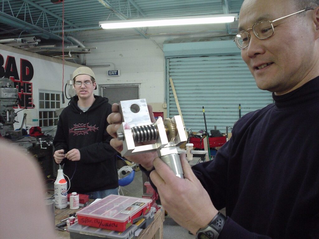 Sully Chen holding a robot part, 2004