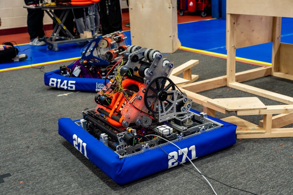 Team 271 2024 robot on the carpet beside a wooden ramp